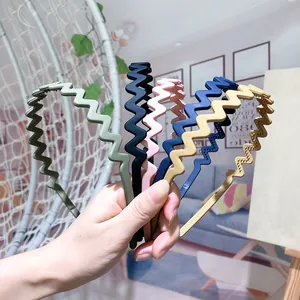 Set of five matte Morandi wave hair hoops in olive, black, pink, blue, and beige