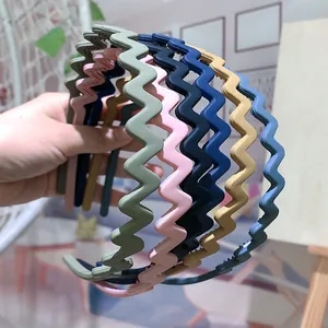 Close-up of colorful wavy matte headbands in Morandi colors with non-slip inner teeth
