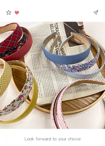 Detail of fabric headbands in assorted plaid and floral prints on a decorative tray