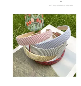 Detail of colorful gingham fabric headbands stacked on a magazine for a pastoral style