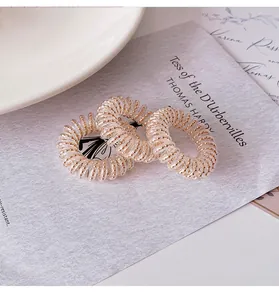 Three-piece set of spiral phone cord hair ties with gold bead accents and clear soft glue