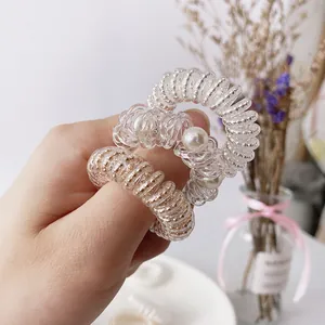 Set of two transparent spiral hair ties with gold beads and white faux pearls