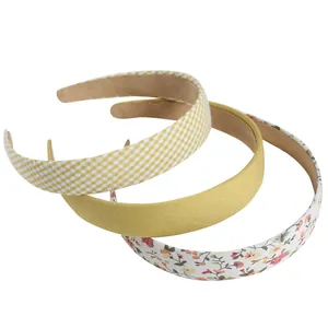 Three-piece floral and checkered wide headbands in yellow, plaid, and white patterns