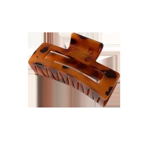 Brown tortoiseshell geometric hair claw clip with rectangular hollow design on white background