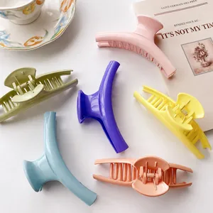 Set of six large candy-colored hair claws in vibrant macaron shades on white background