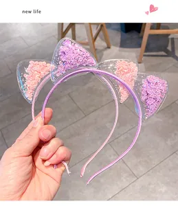 Detailansicht der Katzenohr-Haarreifen in Pink und Lila mit beweglichen Glitzerpailletten