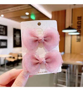 Close-up of pink mesh bow hair clips for girls on a handmade display card