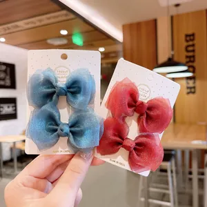 Navy blue and deep red mesh bow hair clips for girls displayed on handmade cards