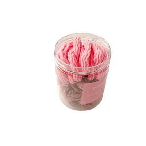 Élastiques à cheveux ondulés roses et marron dans un flacon avec étiquette rose