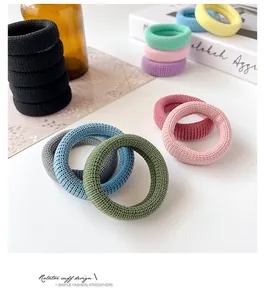 Detailed view of thick knitted seamless elastic hair bands with ribbed texture and soft colors