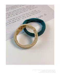 Close-up of seamless nylon hair ties in dark green and khaki with fine ribbed texture