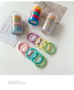Detail of high-elastic seamless hair ties in three clear plastic storage canisters
