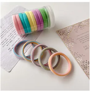 Detail shot of multi-colored seamless elastic hair ties in pastel candy shades and stripes