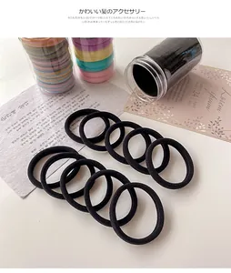 Seamless hair ties set in candy colors inside a transparent cylindrical storage jar