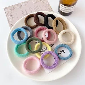 Multi-colored seamless high elastic hair bands set in a decorative ceramic plate