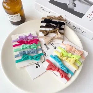 5-piece seamless elastic hair ties set with bows in assorted colors on display cards