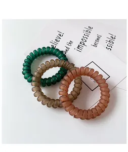 Three-piece matte telephone wire hair ties in olive green, brown, and burnt orange