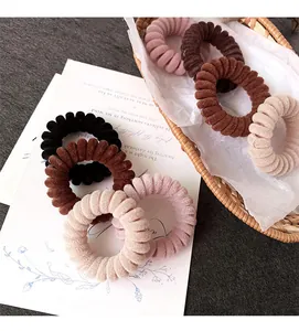 Dettaglio di elastici a spirale floccati in colori della terra in un cestino
