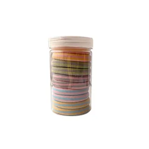 Set of colorful striped high-elastic hair ties in a clear cylindrical storage jar