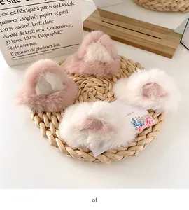 Close-up of four fluffy faux fur cat ear hair clips in soft pink and white colors