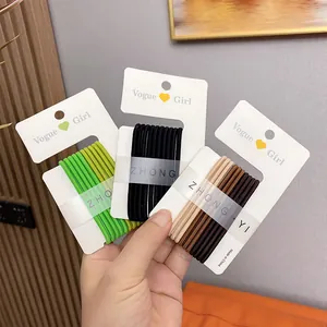 Hand holding candy color high elastic hair ties in green, black, and brown sets