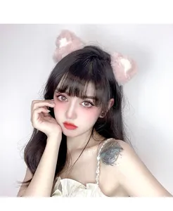 Front view of model wearing plush pink and white cat ear headband with faux rabbit fur
