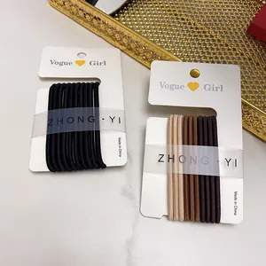 Set of thick candy-colored elastic hair ties in black and brown on display cards