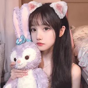 Cute plush cat ear hair clips and purple rabbit toy in cozy bedroom setting