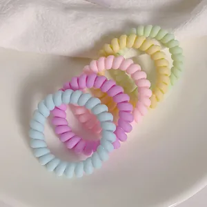 Set of 5 pastel candy-colored spiral hair ties in macaron blue, purple, pink, yellow, and green