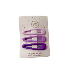 Three-piece set of matte purple gradient BB hair clips on a white decorative card