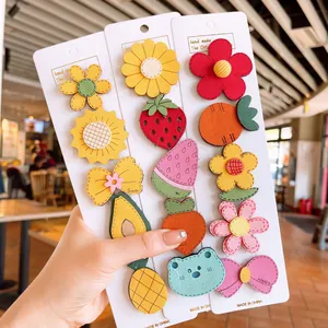 Detailed view of colorful handmade cartoon hair stickers on white display cards for girls