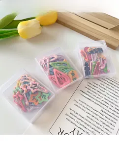 Detail of candy-colored polka dot snap hair clips in transparent storage boxes