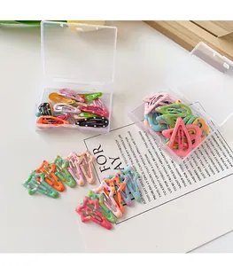 Detail of colorful polka dot BB hair clips in mini star and oval shapes with storage box
