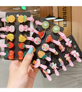 Detailed view of colorful fruit and animal resin hair clips on a display card