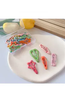 Detailed view of colorful candy-colored polka dot hair clips in a clear storage box