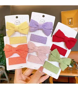 Detailed view of hand-knitted bow hair clips set for kids in various bright colors
