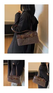 Detailed view of leopard print shoulder bag with brown leather straps and gold buckle