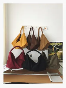 Detailed display of high capacity hobo bags in six muted colors with suede texture