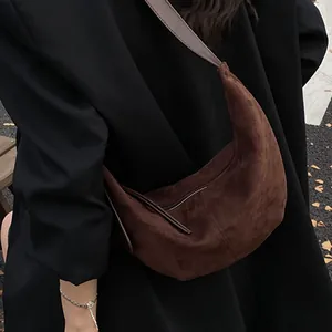 Σκούρα καφέ hobo τσάντα από ματ σουέτ φορεμένη από μοντέλο σε εξωτερικό δρόμο