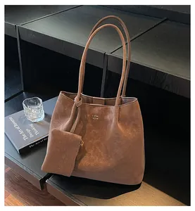 Brown vintage textured tote bag with matching mini pouch on a dark aesthetic background
