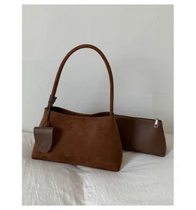 Detail of a dark brown frosted suede shoulder bag with a matching small coin purse set