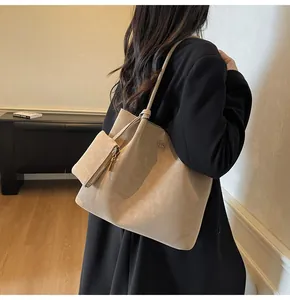 Detailed side view of large beige tote bag with a matching small zipper pouch on shoulder
