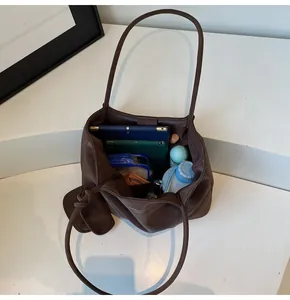 Spacious dark brown tote bag showing large capacity for tablets, bottles and daily items