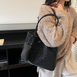 Fashionable black matte tote bag for women with small coin purse and printed text detail