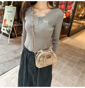 Brown vintage denim Boston bag with top handles and adjustable crossbody strap