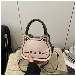 Detail of cute cat shaped crossbody bag showing plush texture and embroidery craftsmanship