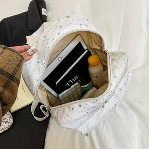 Internal capacity of white canvas backpack showing tablet and daily essentials