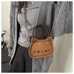 Detail of cute cat shaped crossbody bag with matte texture and embroidered whiskers
