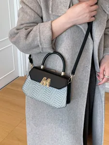 Vintage houndstooth crossbody bag with black leather flap and gold M-shaped metal buckle