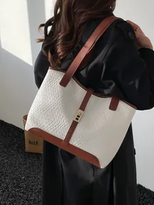 Minimalist bicolor tote bag in white woven leather with brown straps and metal buckle